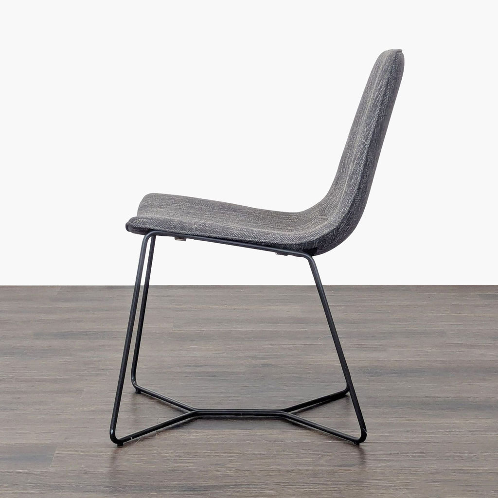 Modern bentwood chair with padded seat and black iron base in dining room style.