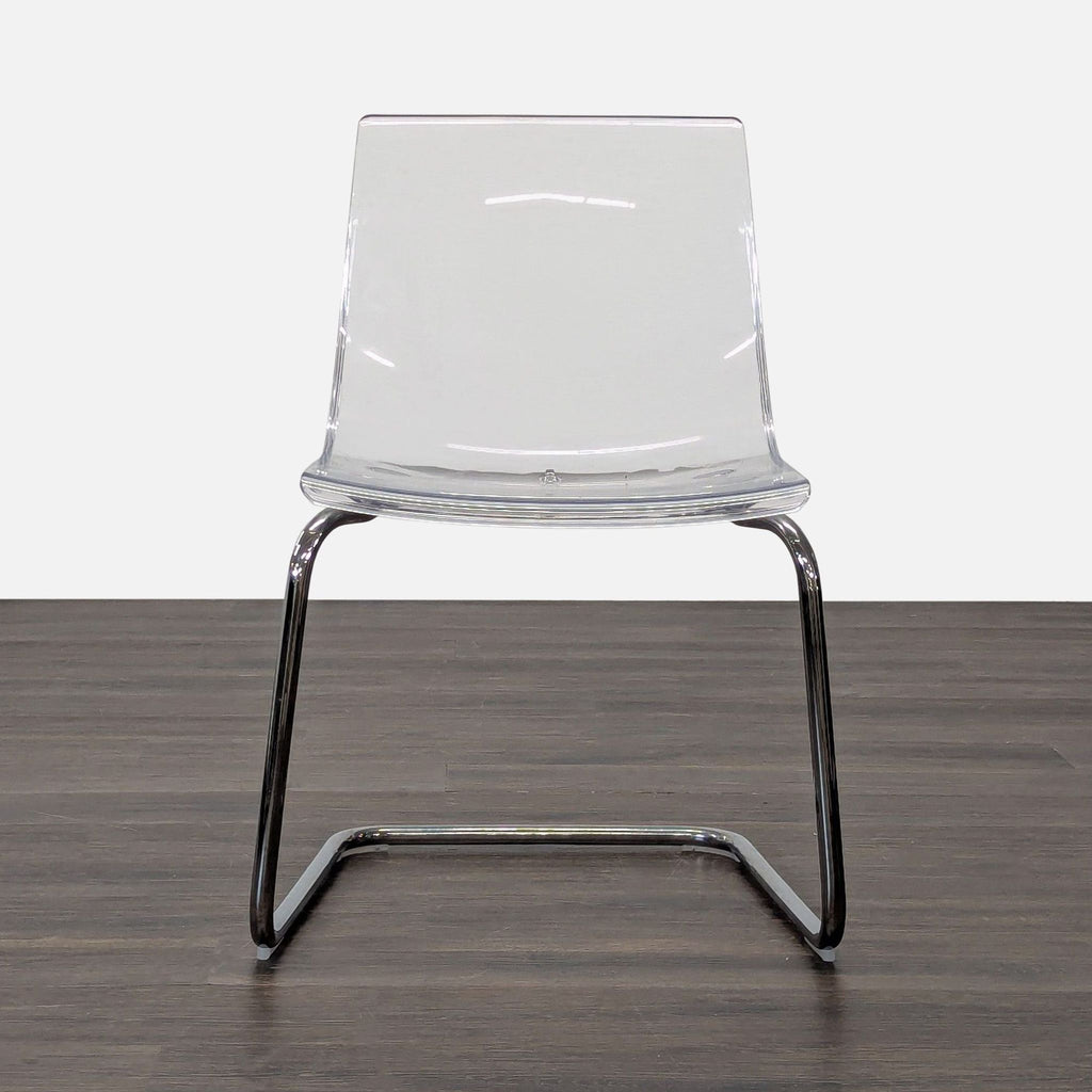Modern Ikea dining chair with a plastic seat and chrome-plated metal legs.  