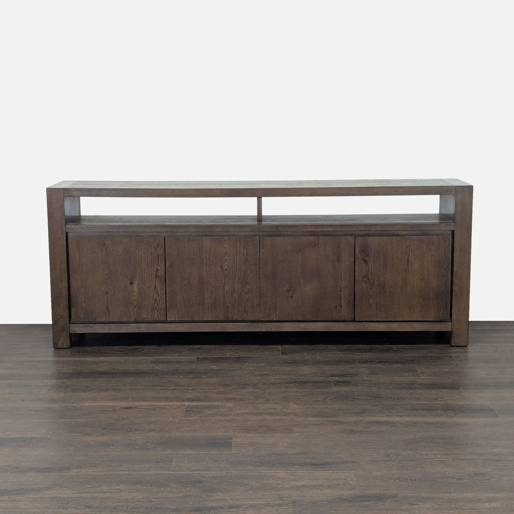 Entertainment center by Living Spaces featuring double doors, interior shelving, and open upper shelves.