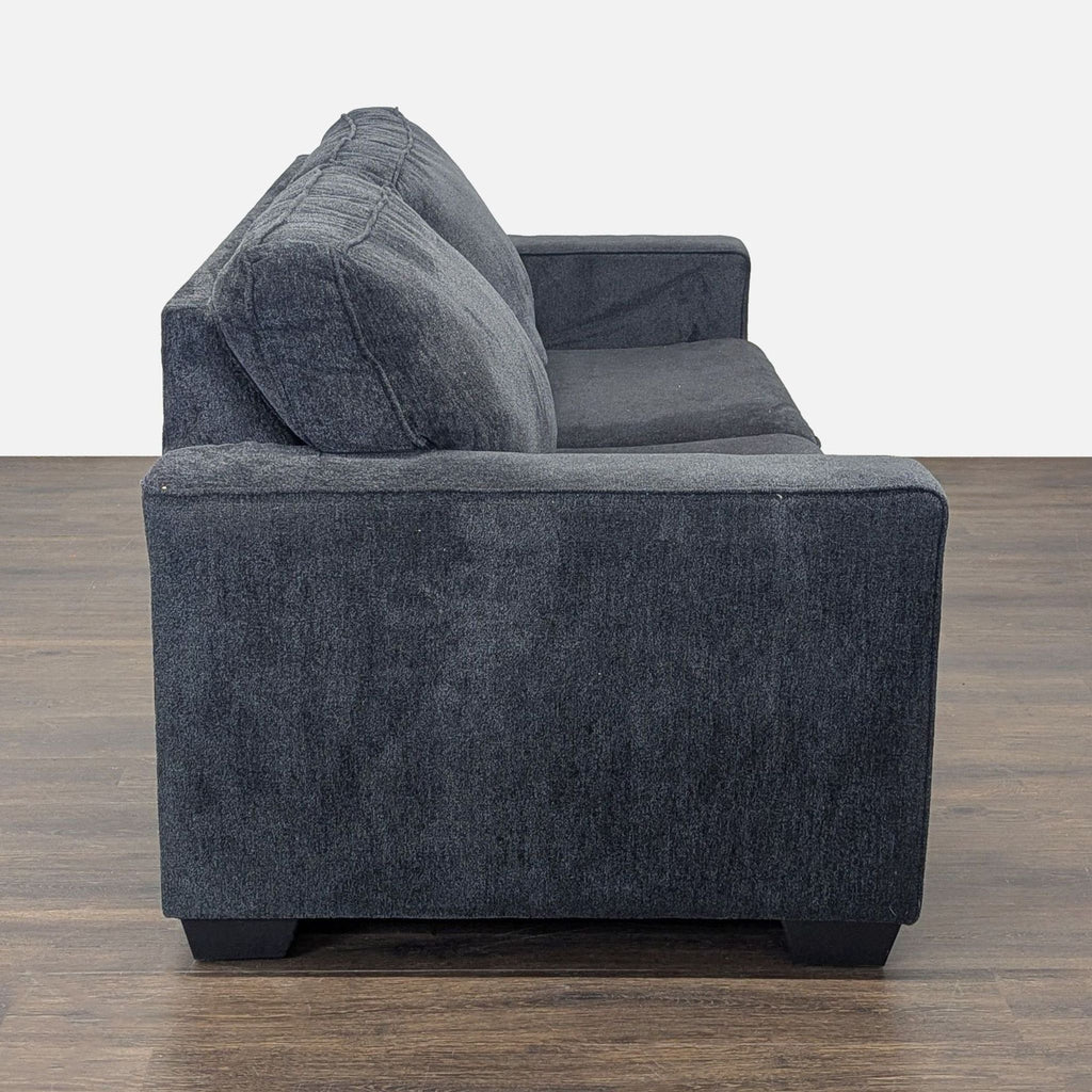 Contemporary queen-size sleeper sofa by Ashley Furniture, ideal for both lounging and accommodating overnight visitors.