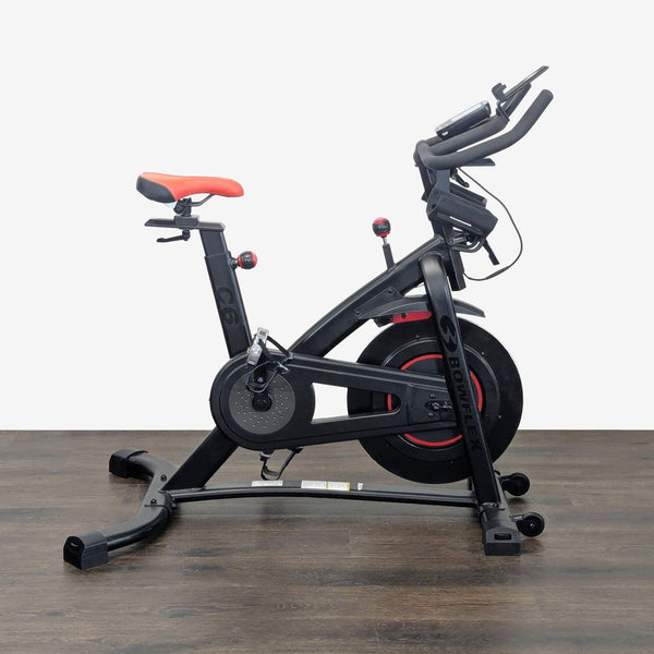 Bowflex C6 indoor cycling bike with adjustable magnetic resistance and device holder for home workouts.