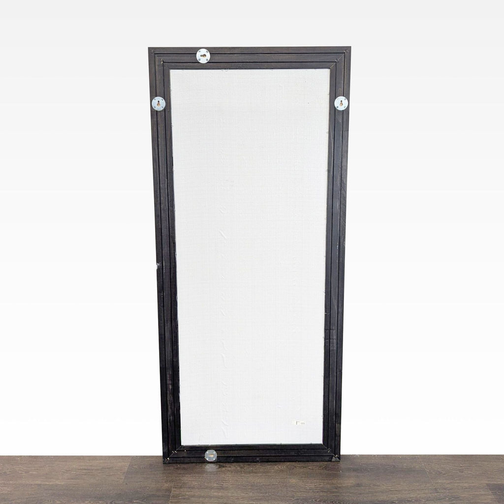2. Back view of rectangular Ikea mirror, showing mounting hardware and black frame against white backing.