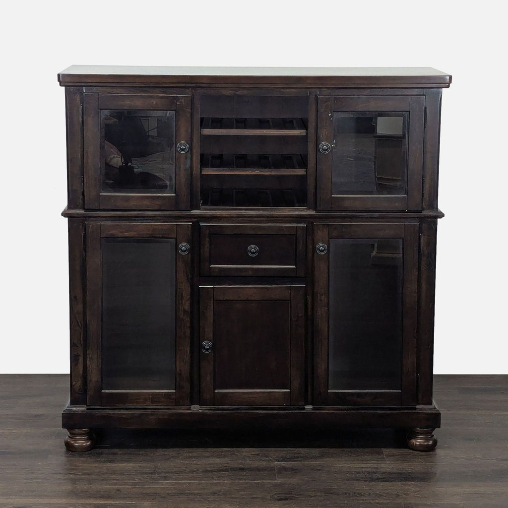 Cherry sideboard with glass-door cabinets, a drawer, open wine racks, and bun feet by Ashley Furniture.