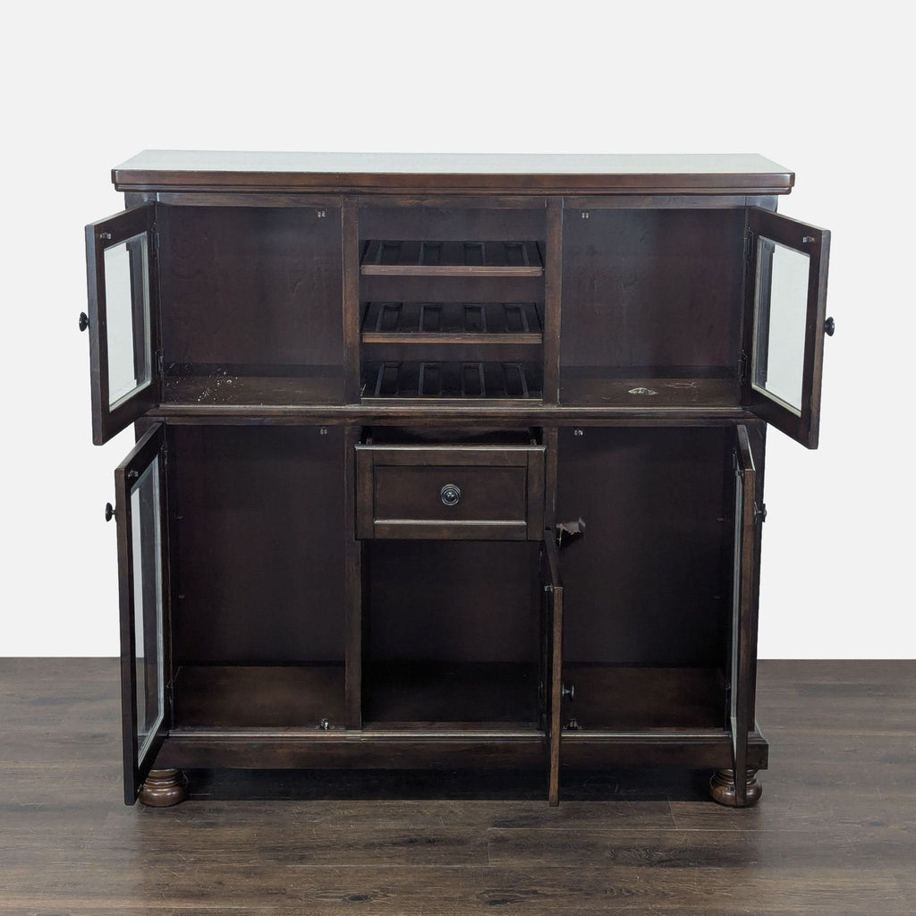 Ashley Furniture sideboard in cherry veneer featuring wine racks, glass cabinets, and a central drawer.