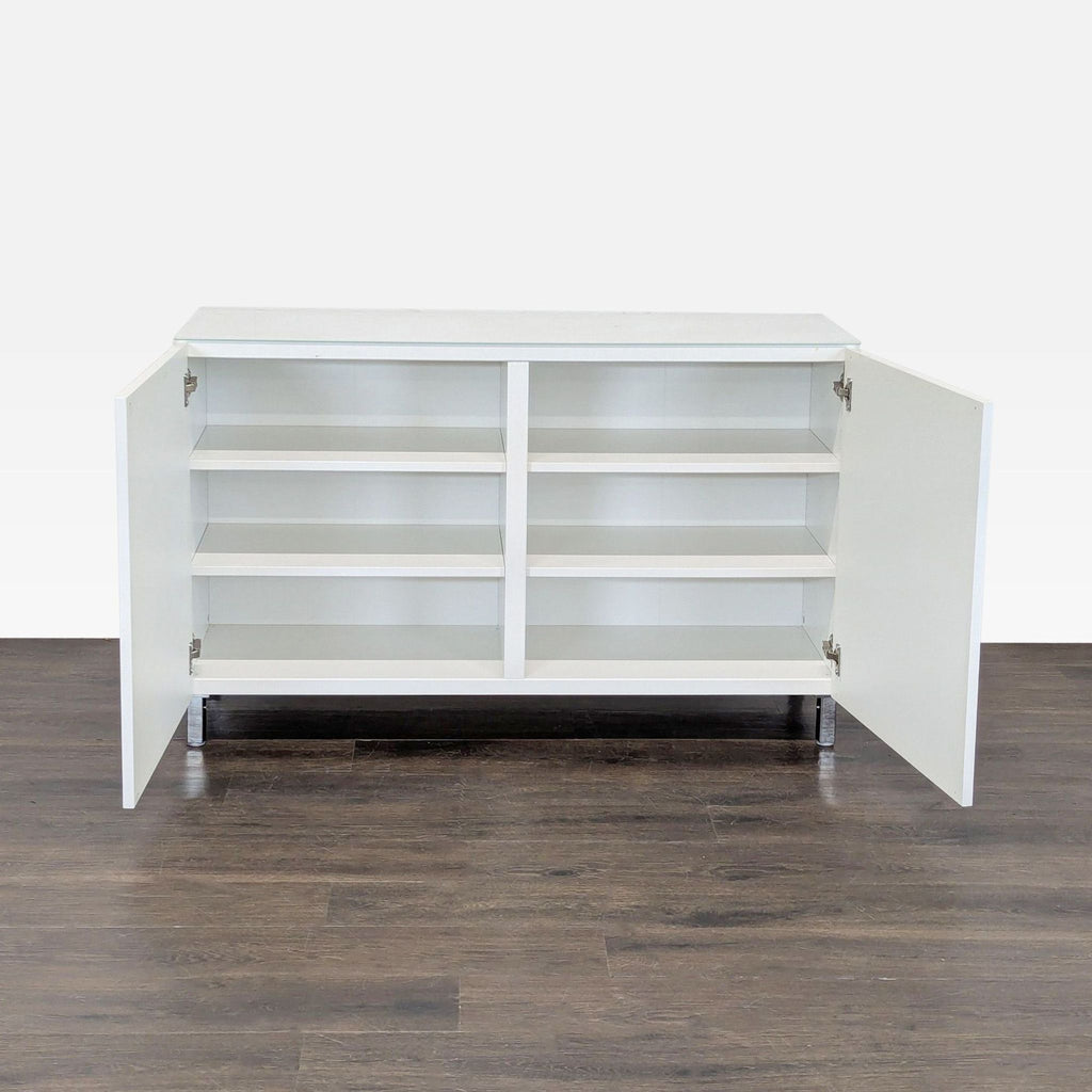 Modern white cabinet by Ikea featuring multiple shelves and sleek metal legs for versatile storage needs.