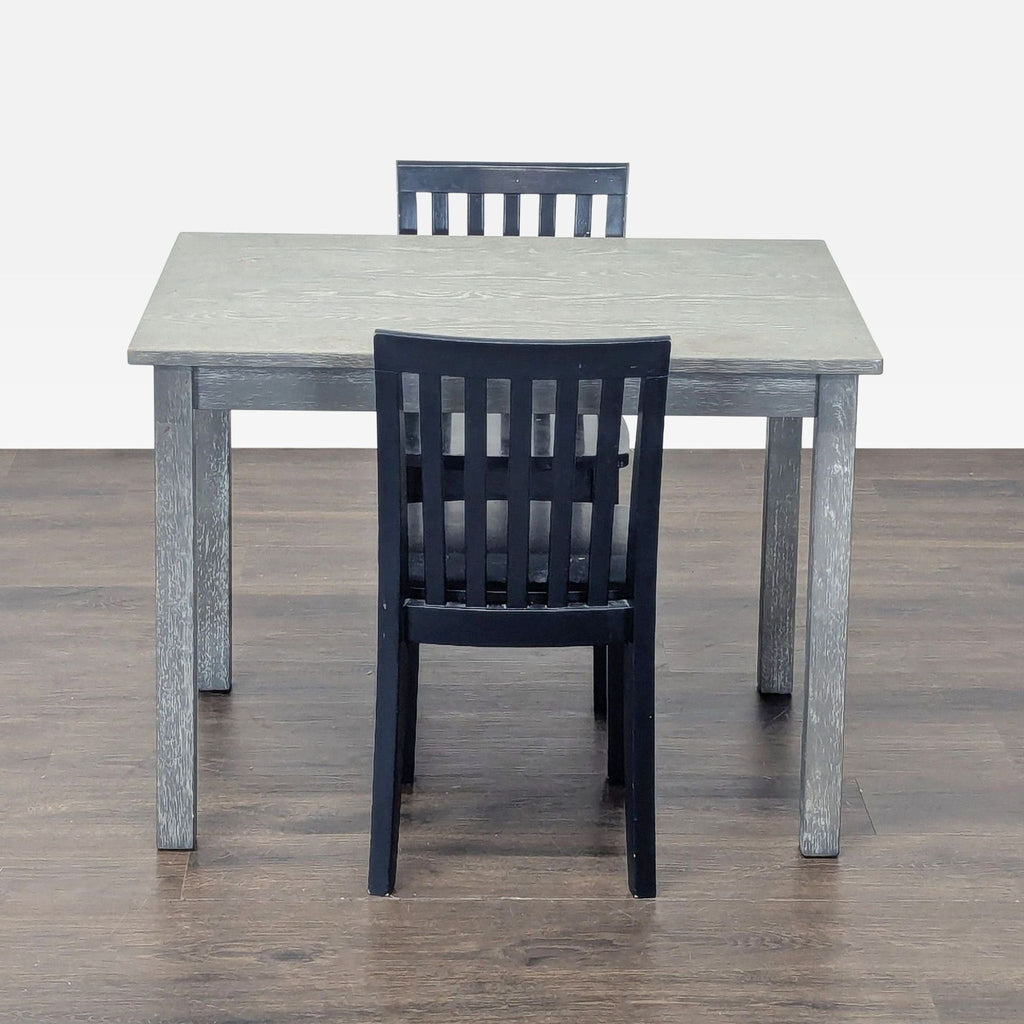 Neutral gray Pottery Barn kids dining table with sturdy solid wood and slatted detail, perfect for homework or playrooms.  