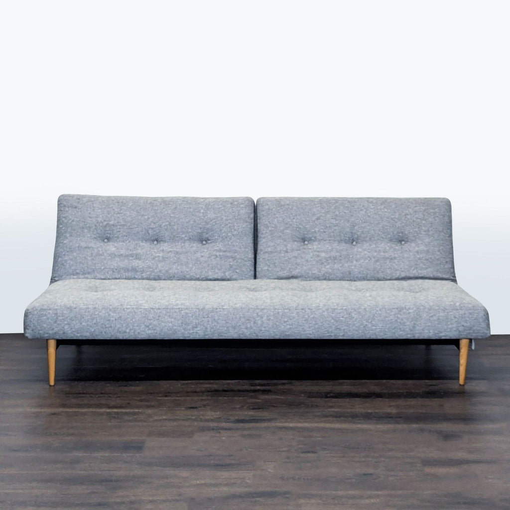 1. West Elm sleeper sofa in gray fabric with tufted backrest, wooden legs, modern style, fits living rooms.