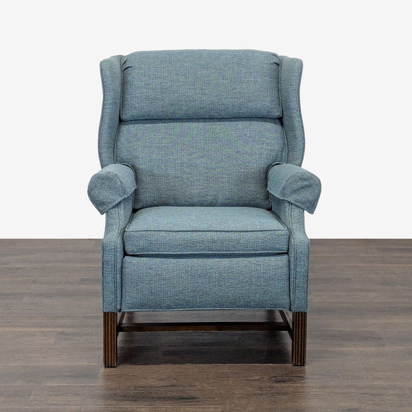 Blue recliner lounge chair with cushioned seat, padded armrests, and wooden legs, perfect for relaxing.