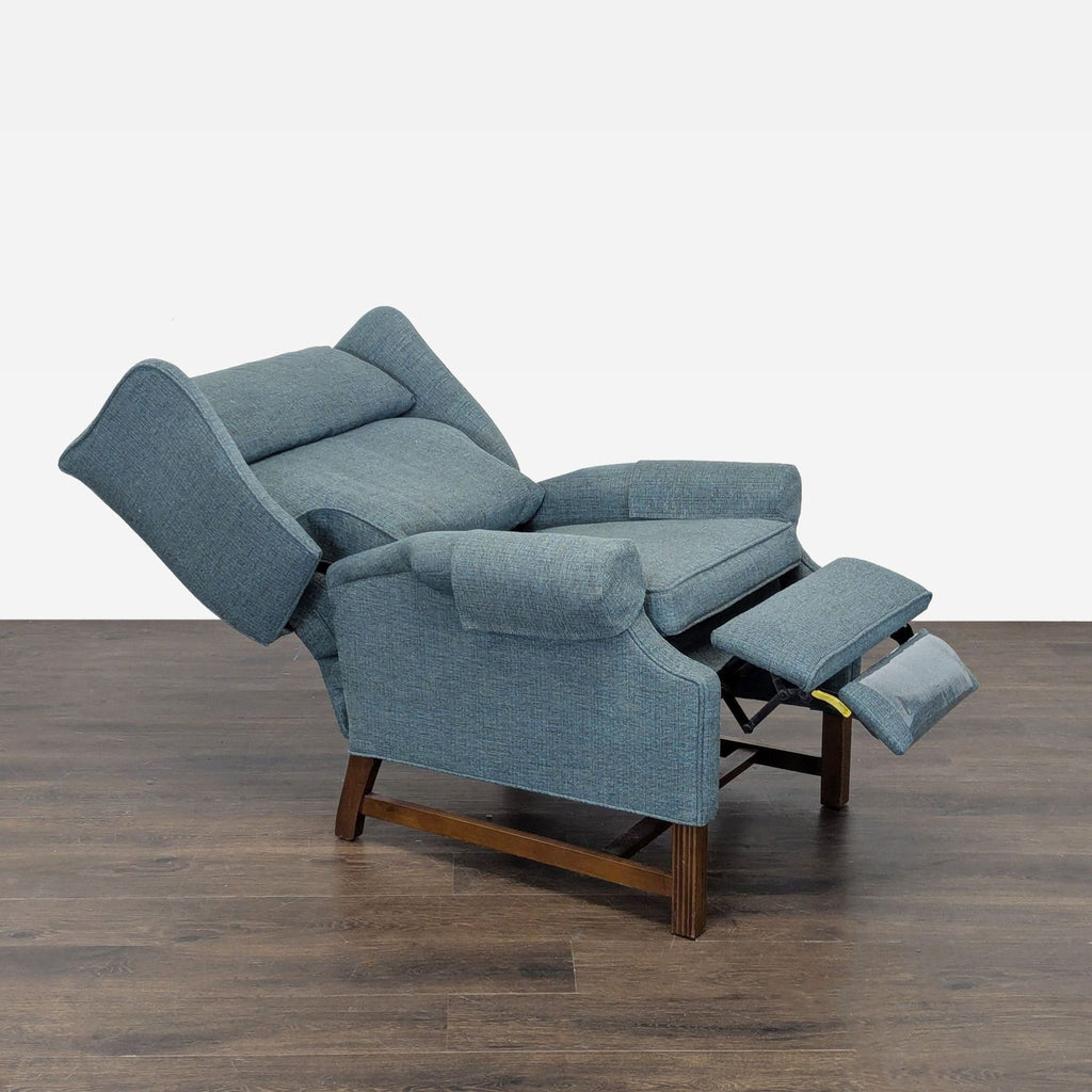 Modern blue lounge recliner chair featuring soft padding, supportive back, and sturdy wooden legs for comfort.