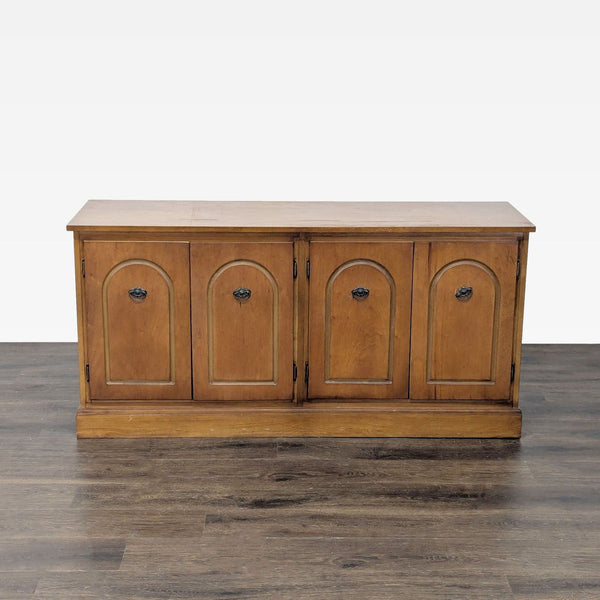 1. Wooden sideboard with four closed paneled doors, simple black handles, and a classic, rectangular design.