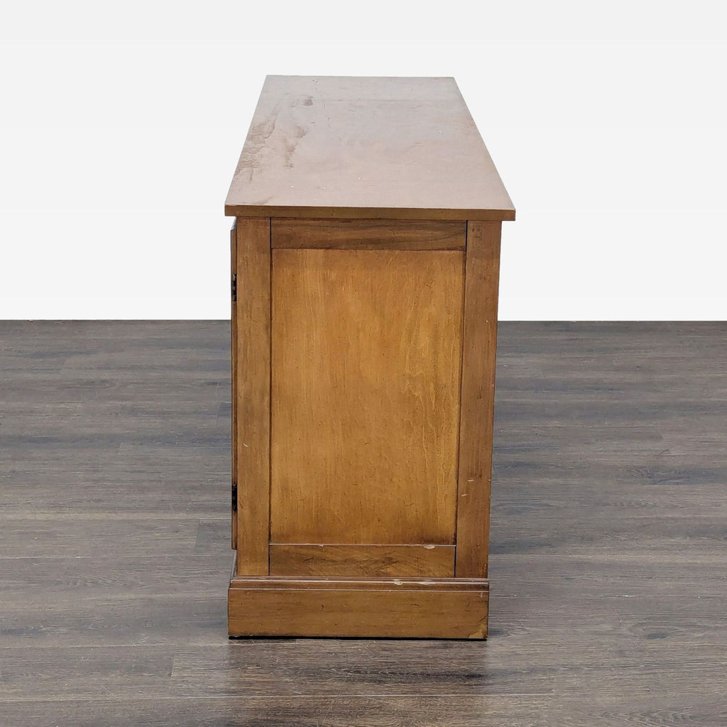 3. Side profile of a wooden sideboard, highlighting the smooth, flat surface and paneled side construction.