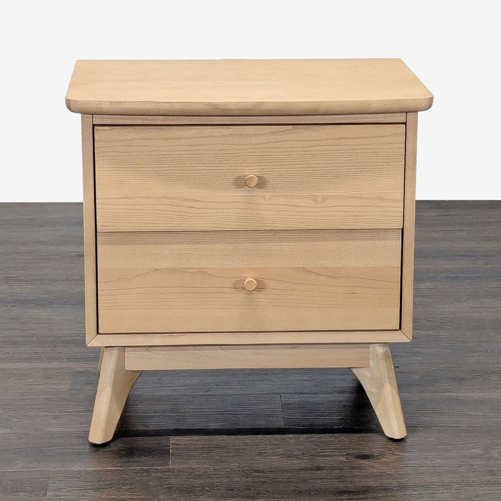1. Light wood end table with two drawers, flat top, and angled legs, placed on a dark wood floor.