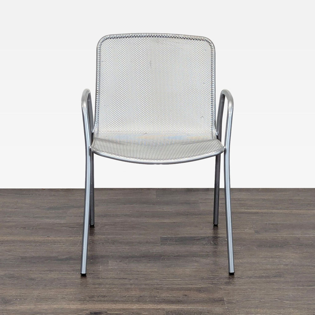 Modern silver chair with metal mesh design, armrests, and sturdy frame; ideal for indoor or outdoor use.  