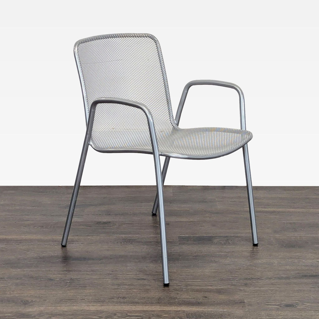 Room and Board chair featuring sleek metal mesh, comfortable armrests, and lightweight sturdy construction.  
