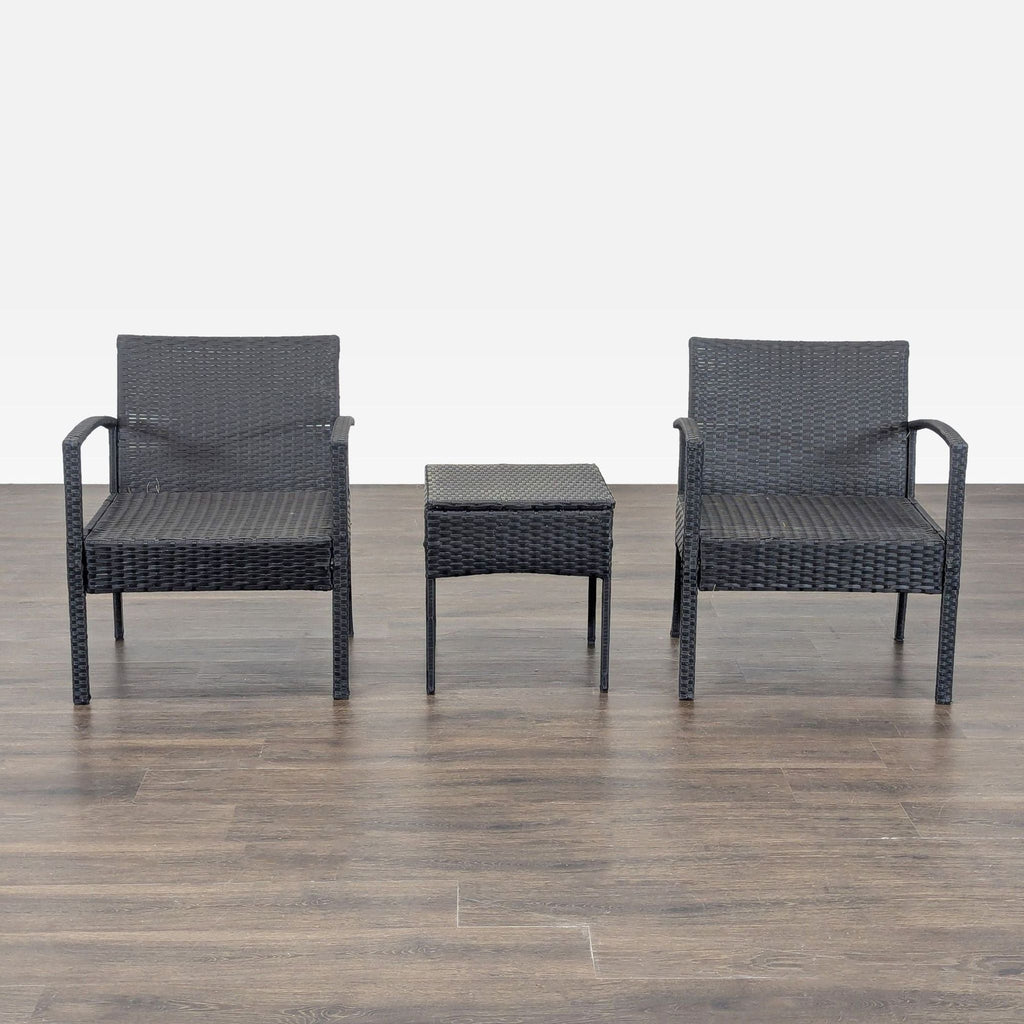 Set of two black wicker chairs and a matching table, ideal for patios or balconies.