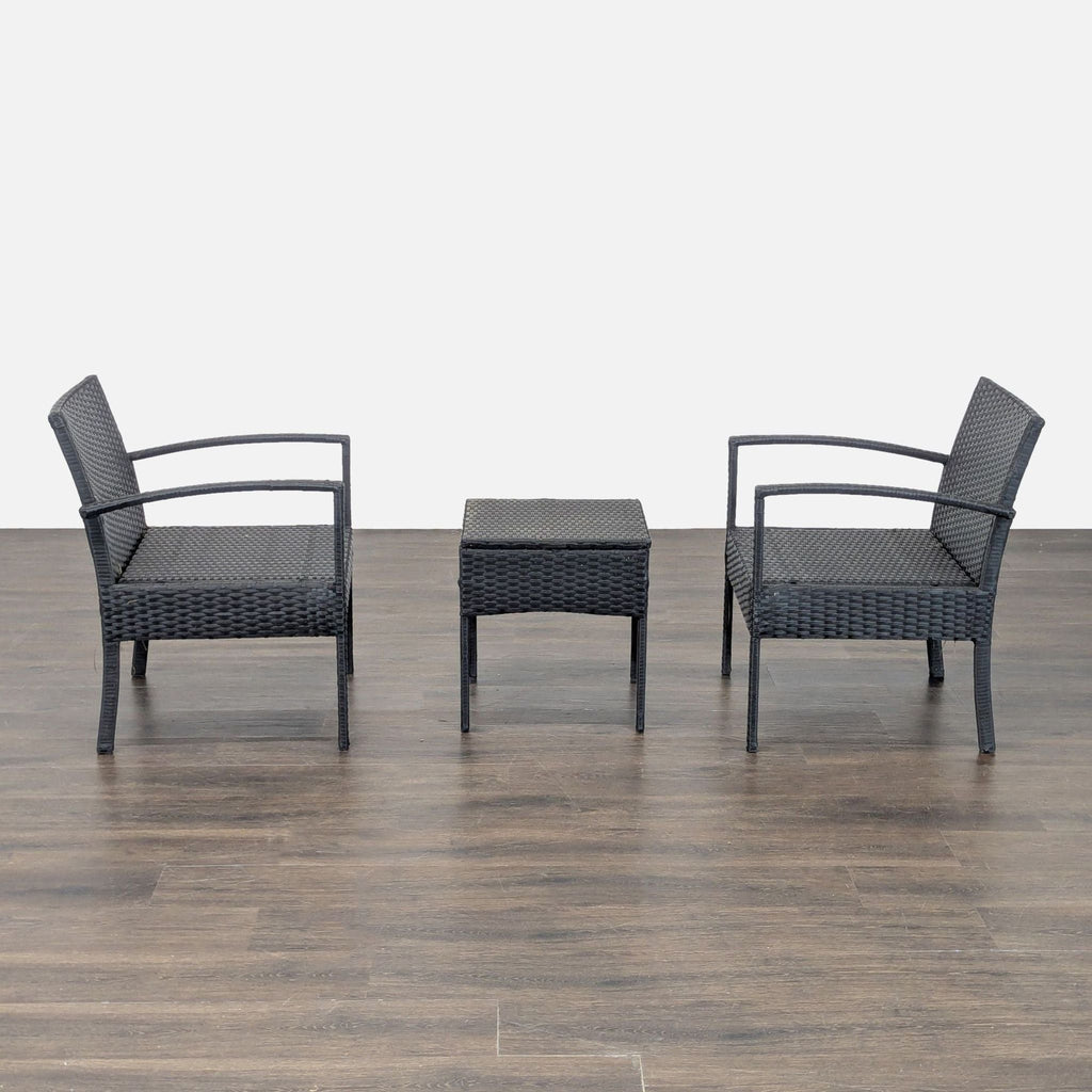 Modern black plastic wicker patio set with two chairs and a small table, perfect for outdoor use.