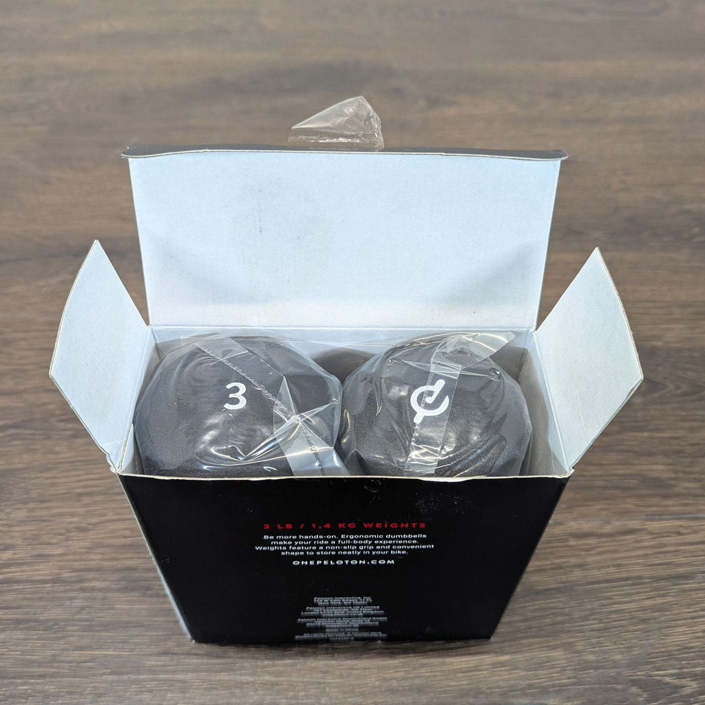 Set of two Peloton dumbbells, 3 pounds each, displayed with packaging for versatile workout routines.