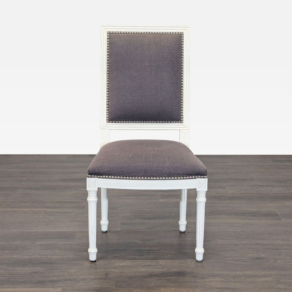 French-style dining chair with wood X-back, linen seat, and nailhead trim by Jonathan Adler.