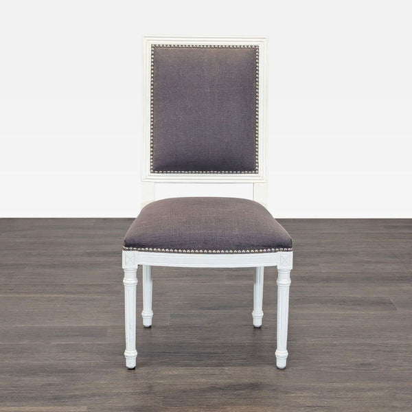 French-style dining chair with wood X-back, linen seat, and nailhead trim by Jonathan Adler.