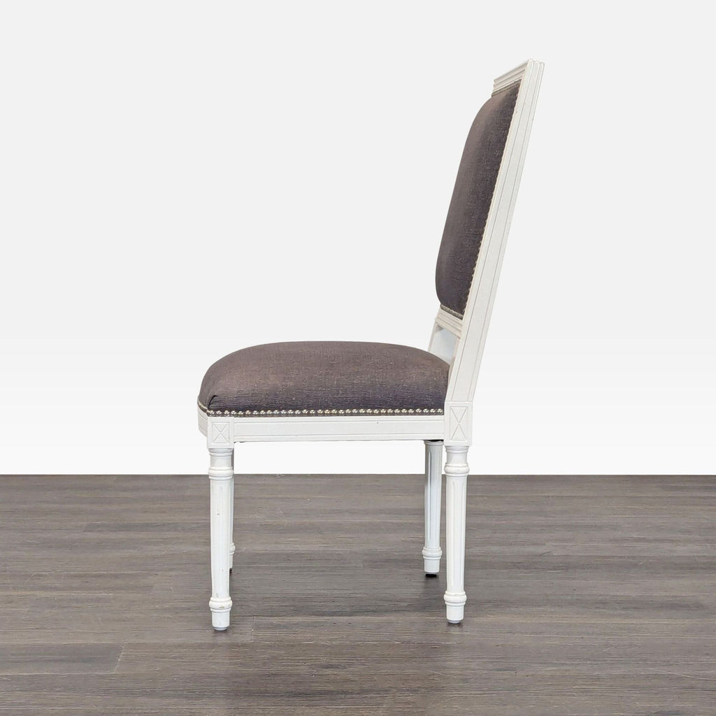 Elegant dining chair by Jonathan Adler: French-inspired wood X-back, linen upholstery, and decorative nailhead trim.