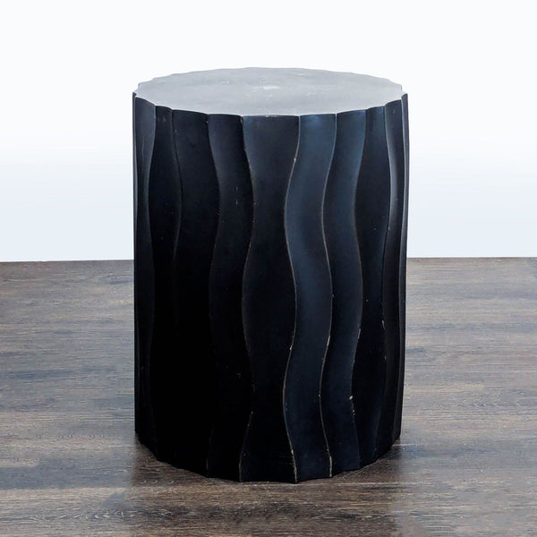 Bronze metal side table from Crate & Barrel, shown with a sleek, modern silhouette.  