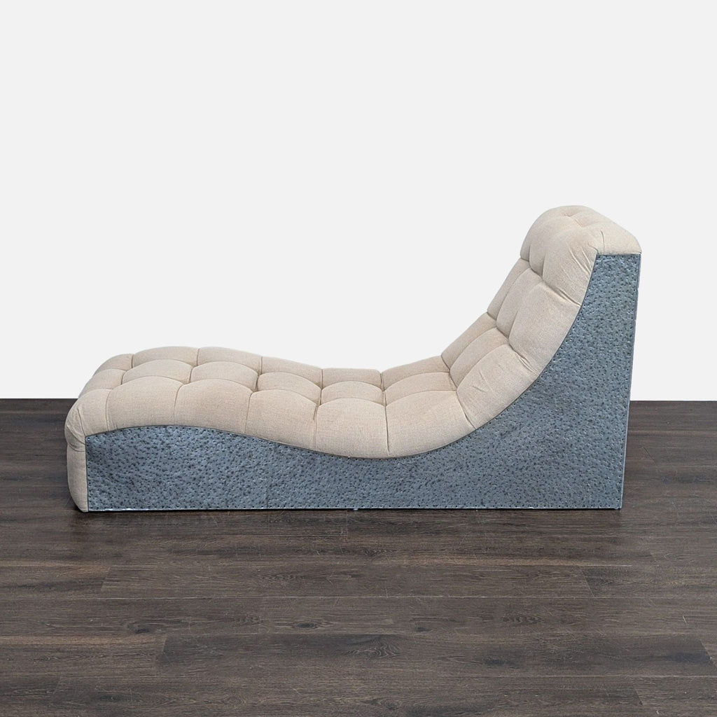3. Profile view of a beige tufted lounge chair with a textured black base and smooth, curving seat.