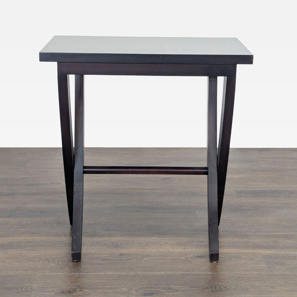 1. Dark wood end table with a rectangular top and angled legs, placed on a wood floor, front view.