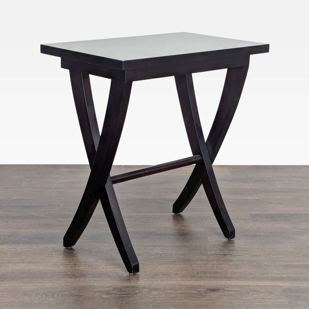 2. Modern dark wood end table featuring a rectangular top and splayed, curved legs, side angle view.