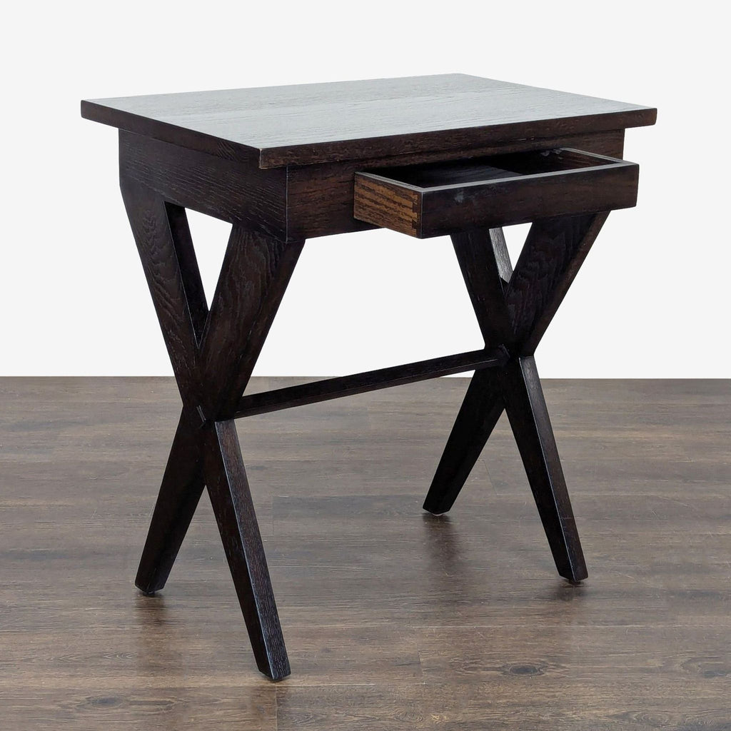 2. Modern dark wood end table with an open drawer and X-shaped legs, placed on wooden flooring.  