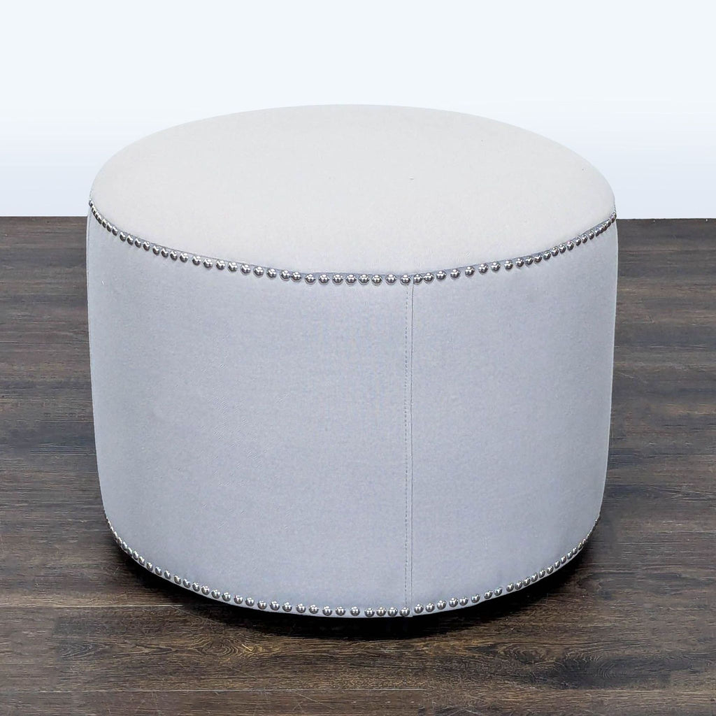 Close-up of nailhead trim detail on a Safavieh stool, featuring elegant metallic accents.  