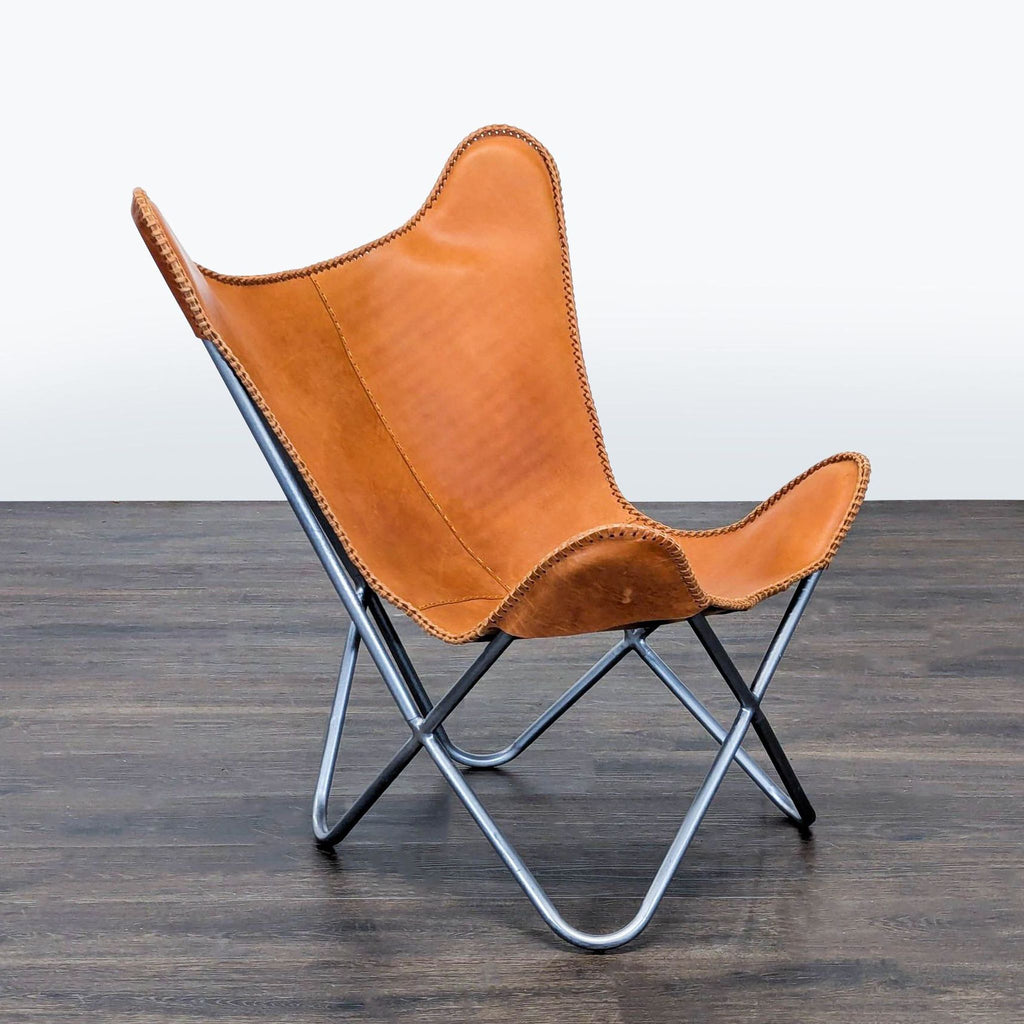 Modern lounge chair featuring a sturdy metal frame and comfortable brown leather seat, ideal for relaxing.