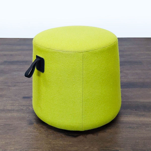 A rounded leather-bottomed pouf by Hightower, designed to stay in place or slide as needed.