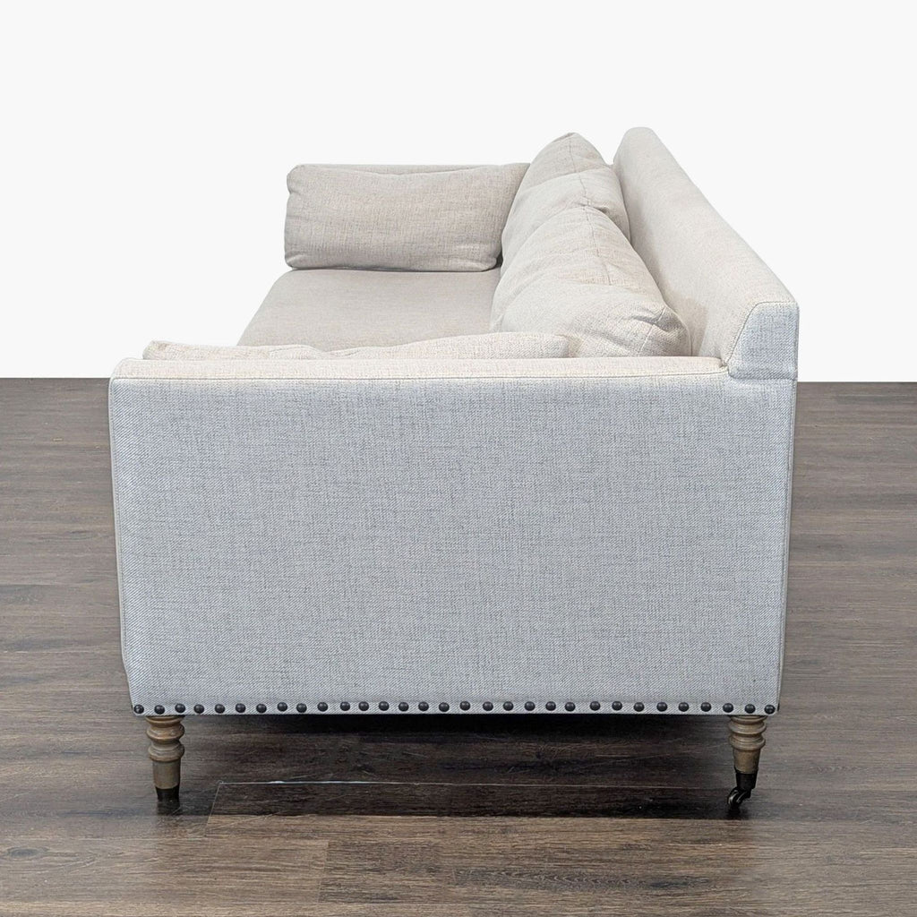 Three-seat Pottery Barn sofa featuring clean lines, two seat/back cushions, and elegant nailhead accents.