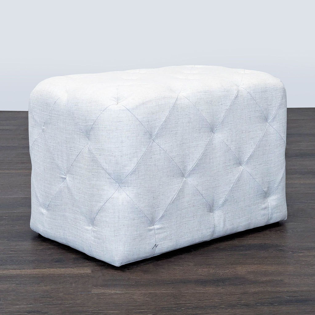 1. Light gray tufted ottoman from Target, perfect for seating or as a footrest, shown on a dark wood floor.