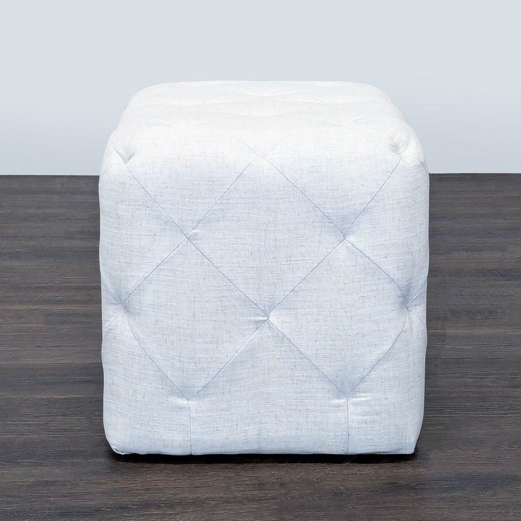 3. Target brand square light gray ottoman with quilted texture, ideal for use as a stool or accent piece.