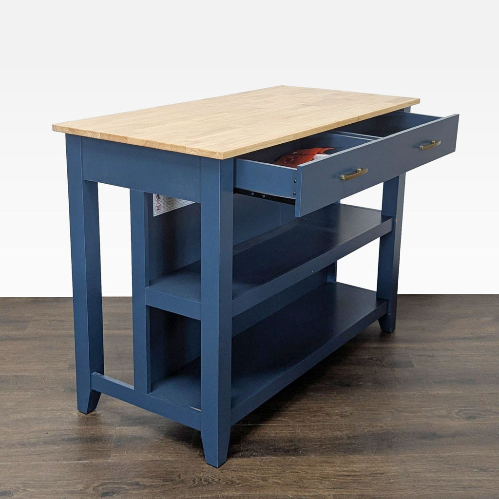 2. Angled view of modern blue kitchen island showing open drawers, sturdy shelves, and gold handles.