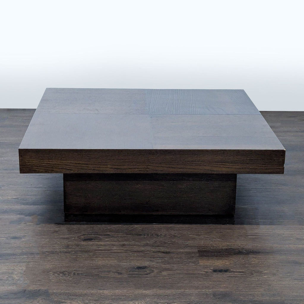 3. Contemporary square coffee table in dark wood, with a minimalist block design and a concealed base.