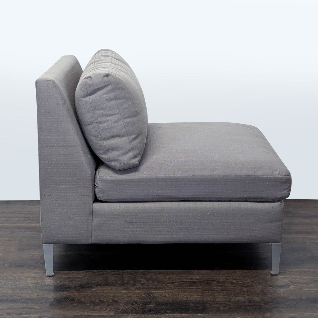 Contemporary CB2 lounge chair featuring wide, cushioned seating and sleek design for stylish home comfort.