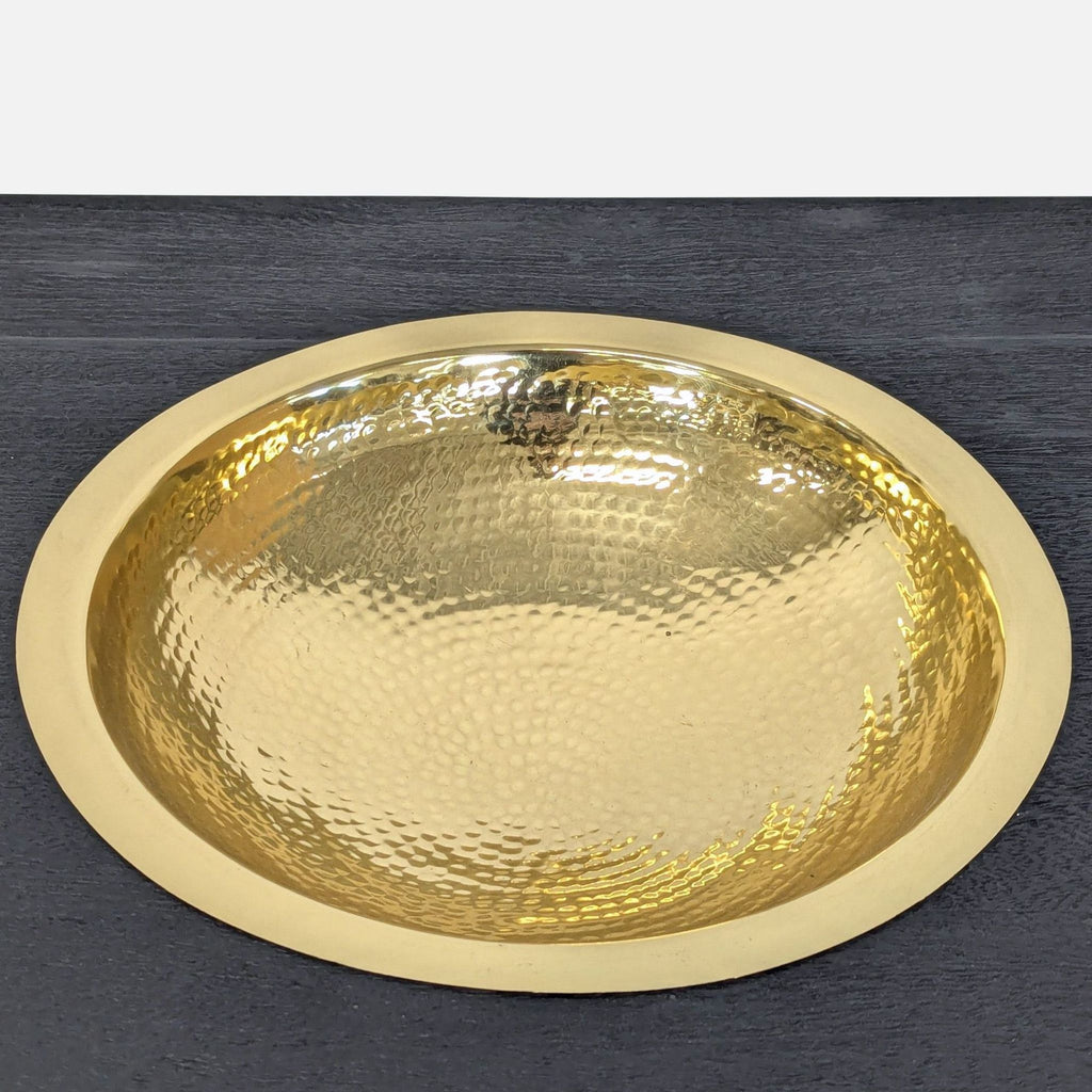 CB2 side table with sand-blasted mango wood top, aluminum legs, open storage shelf, and a built-in brass bowl.