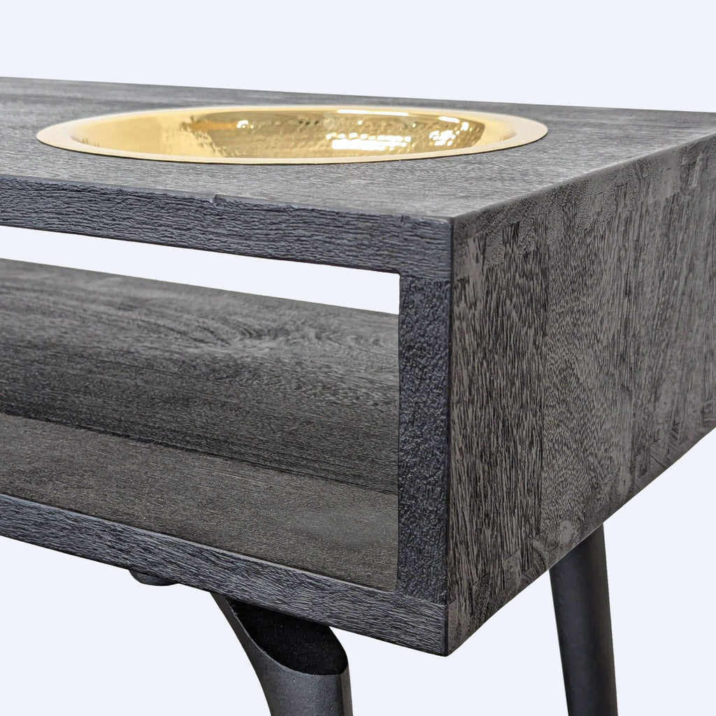 Modern side table by CB2 featuring a removable hammered brass bowl, dark double-stained wood, and angled metal legs.