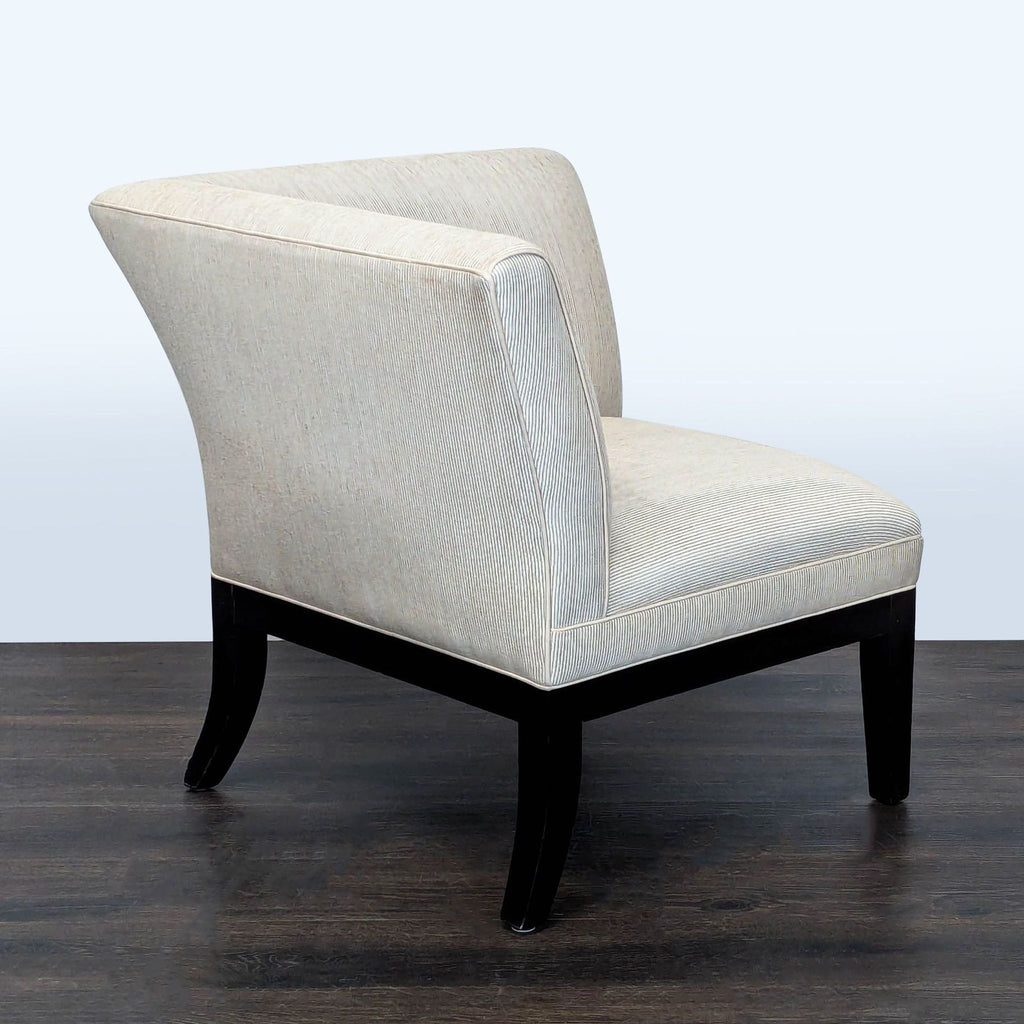 Compact lounge chair featuring soft striped upholstery and sturdy dark wooden legs, ideal for small spaces.  
