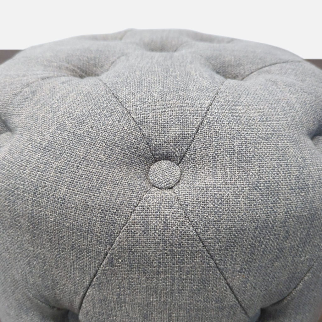 Tufted ottoman by Safavieh, upholstered with visible button detail, one button missing, used as a stool.