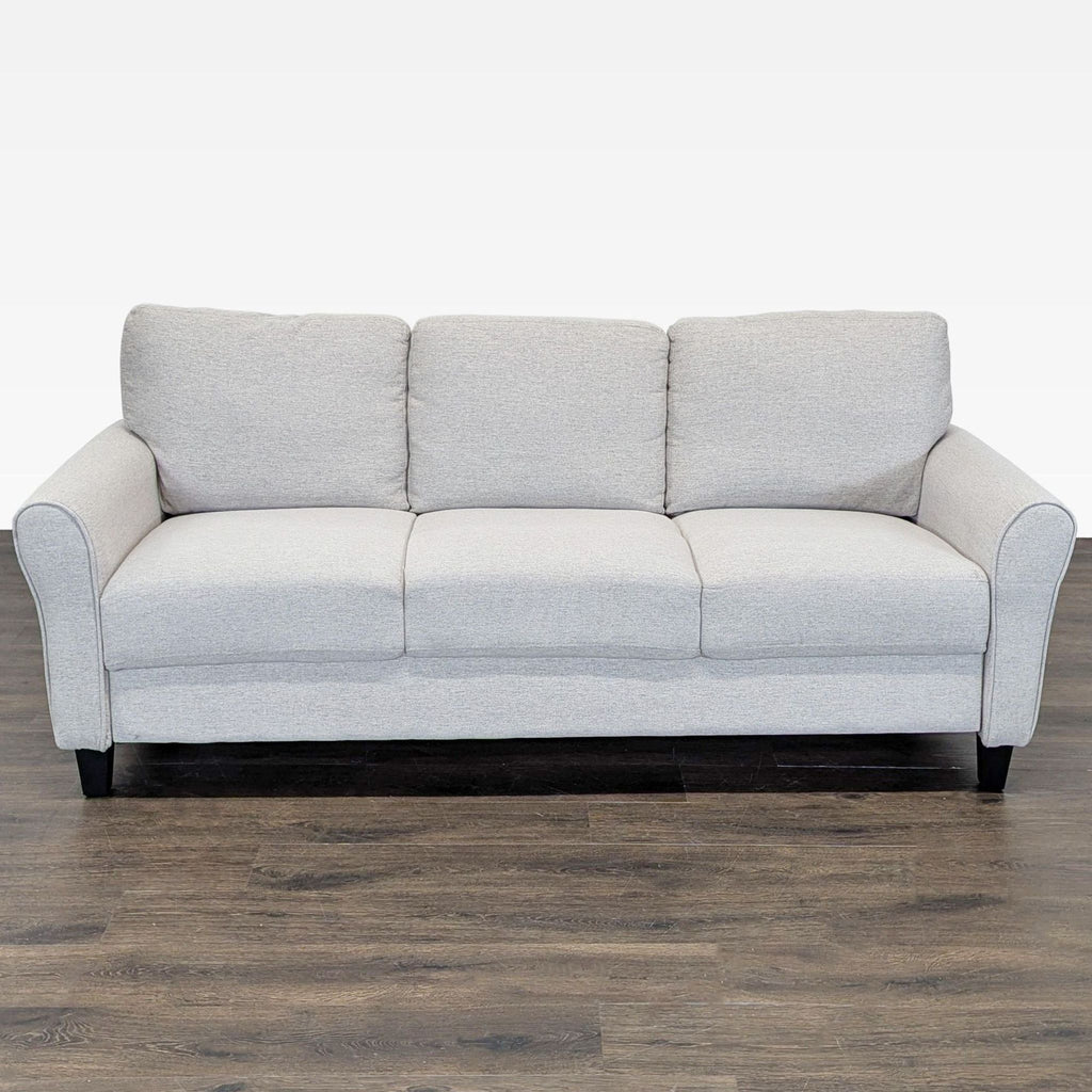 Living Spaces 3-seat sofa in sand fabric with rolled arms and spacious cushions for a modern living room.