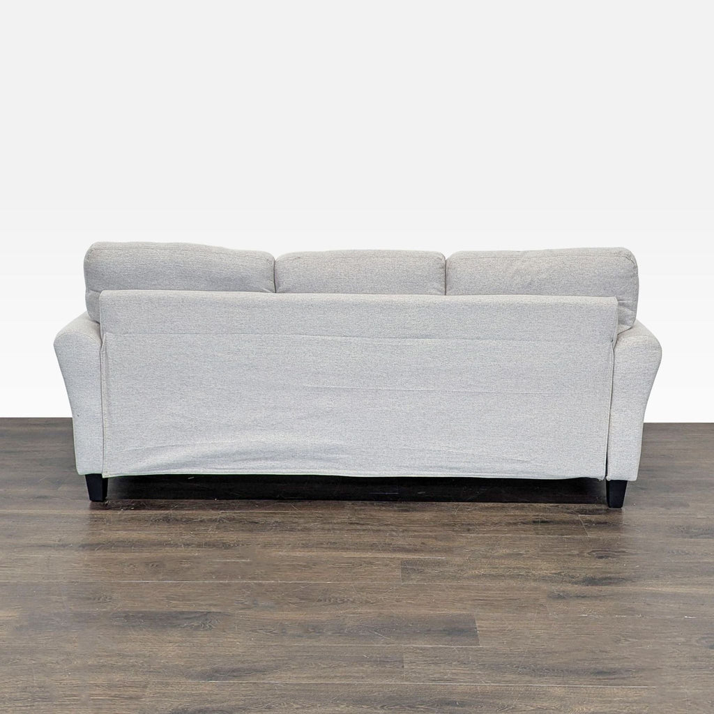 Modern 3-seat sofa by Living Spaces in soft sand fabric with roomy seats, perfect for any living area.