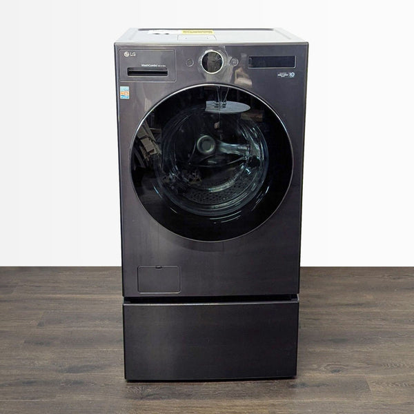 LG front-load washer/dryer combo in sleek black with pedestal, combining washing and drying in one unit.