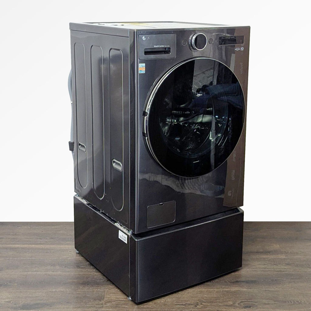 Modern black LG washer/dryer with spacious drum, front-loading design, and built-in storage pedestal.