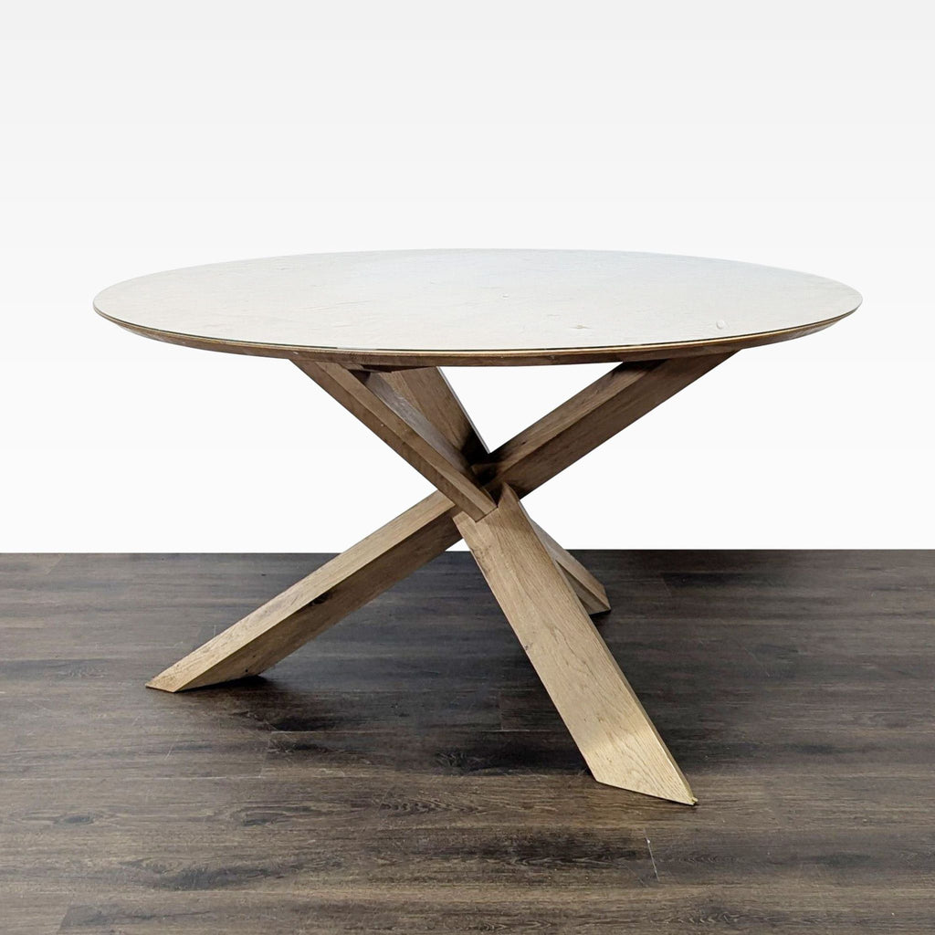 Modern French oak table with unique base design, topped with custom glass, from Ethnicraft's dining collection.