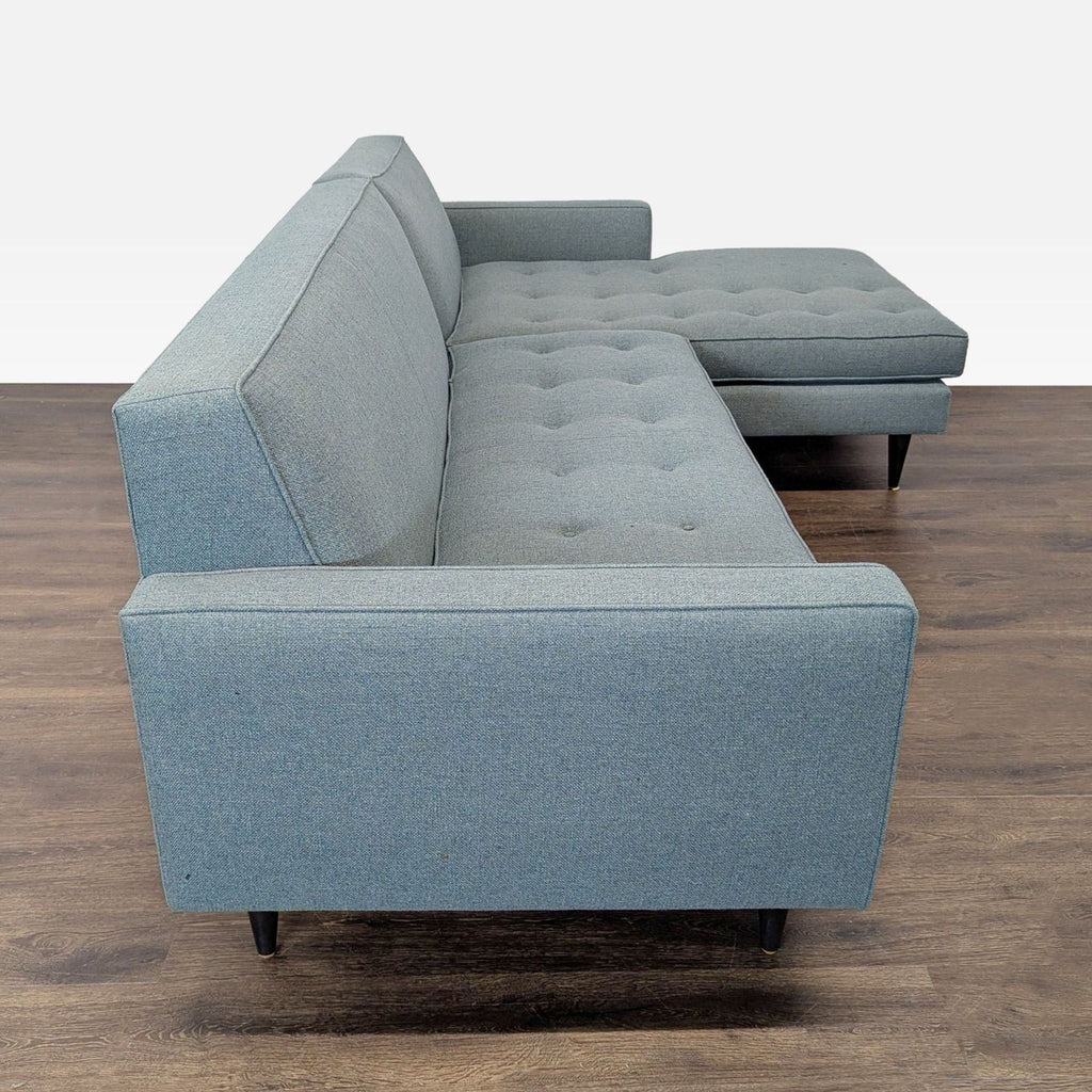 Modern blue Room and Board sectional sofa featuring a spacious chaise and sleek, comfortable design for living rooms.  