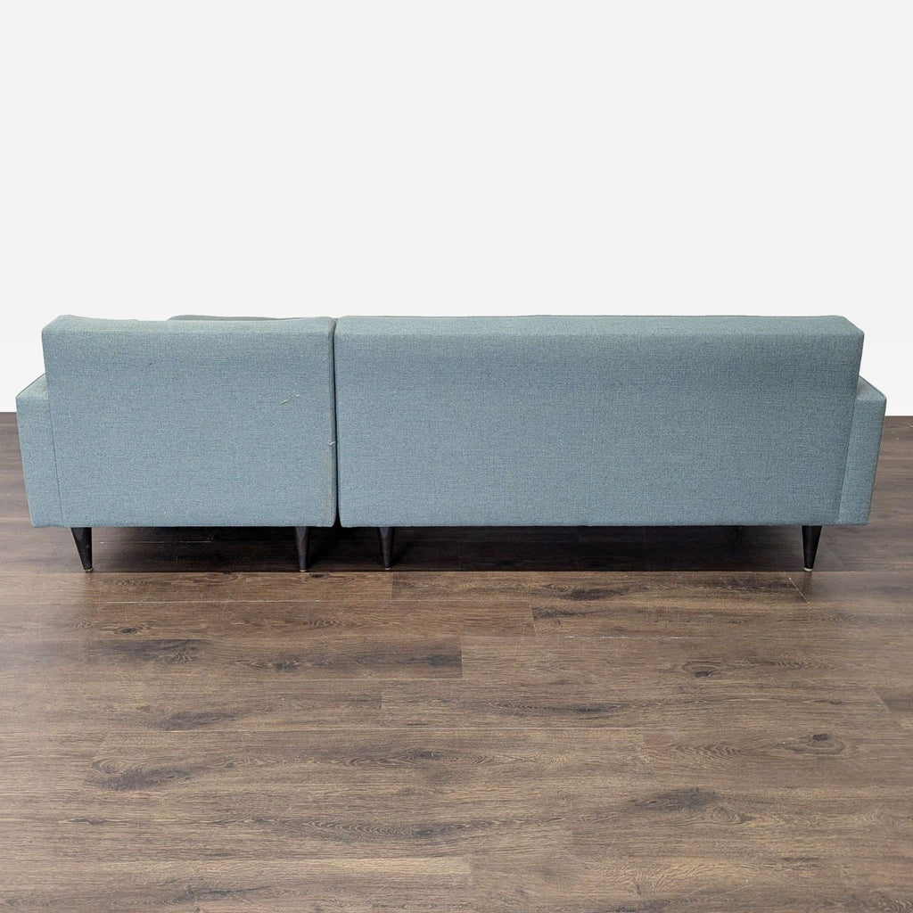 Versatile Room and Board sectional in blue with a roomy chaise, slim arms, and sturdy tapered legs for stylish seating.