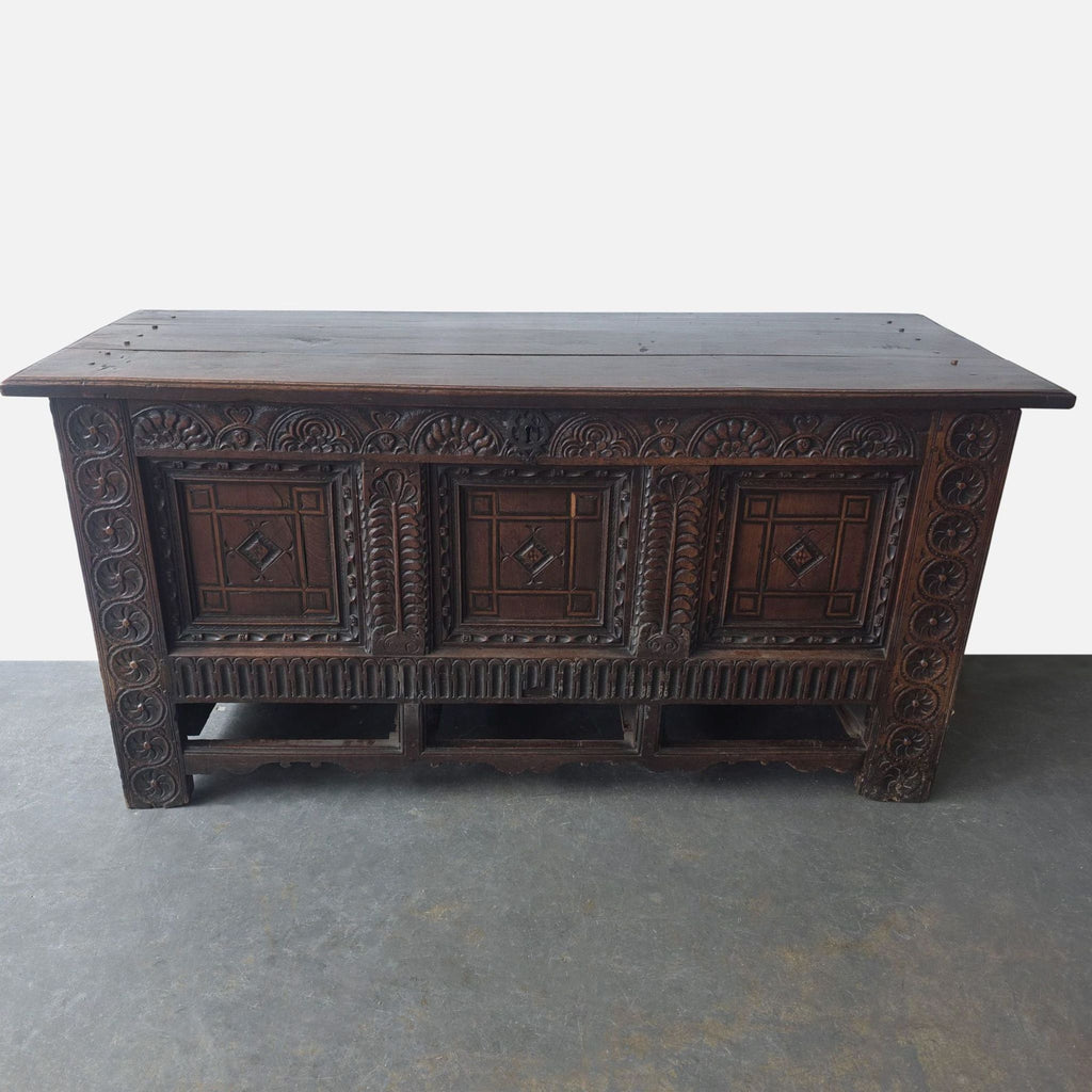 Solid wood Brussels mule chest from the 1500s, featuring rich tones and intricate front carvings.